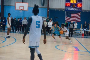 A basketball game in progress, with teams competing intensely and an audience gathered, scoreboard showing 38.6 seconds left in the first period